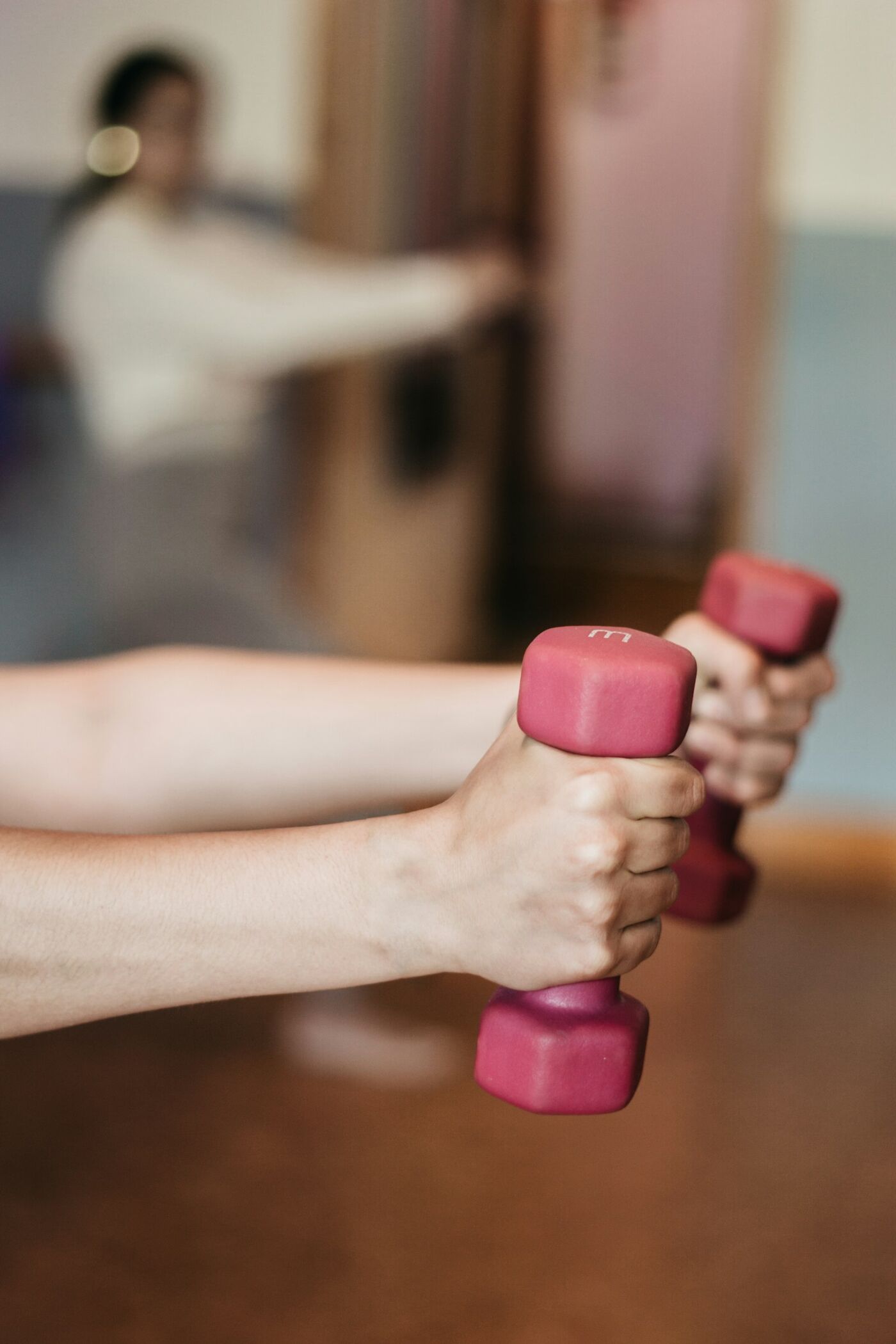 A physiotherapist checking how far a patient can lift her arm