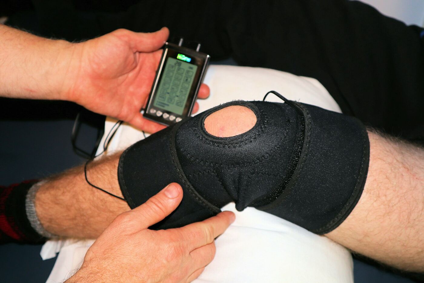 A knee in a support brace during a treatment