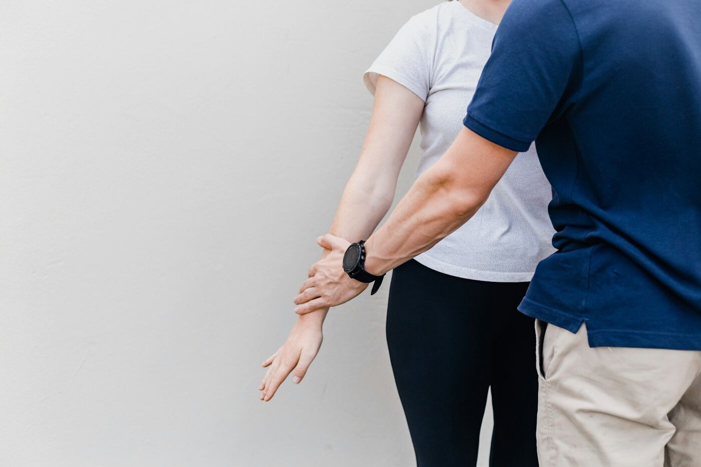 A physiotherapist guiding a patient through a deep hip stretch