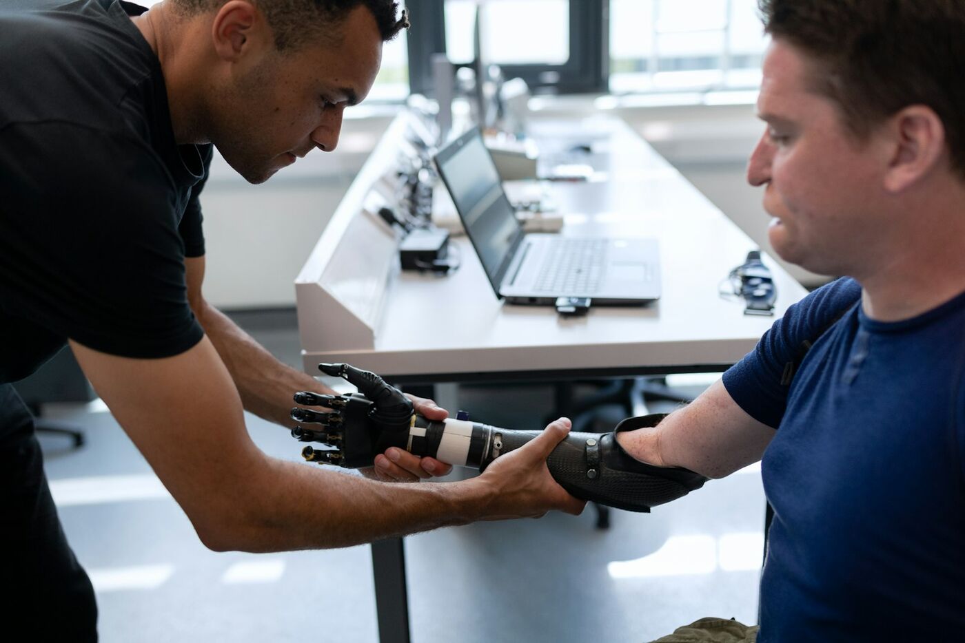 A physiotherapist fitting a support to a patient's wrist