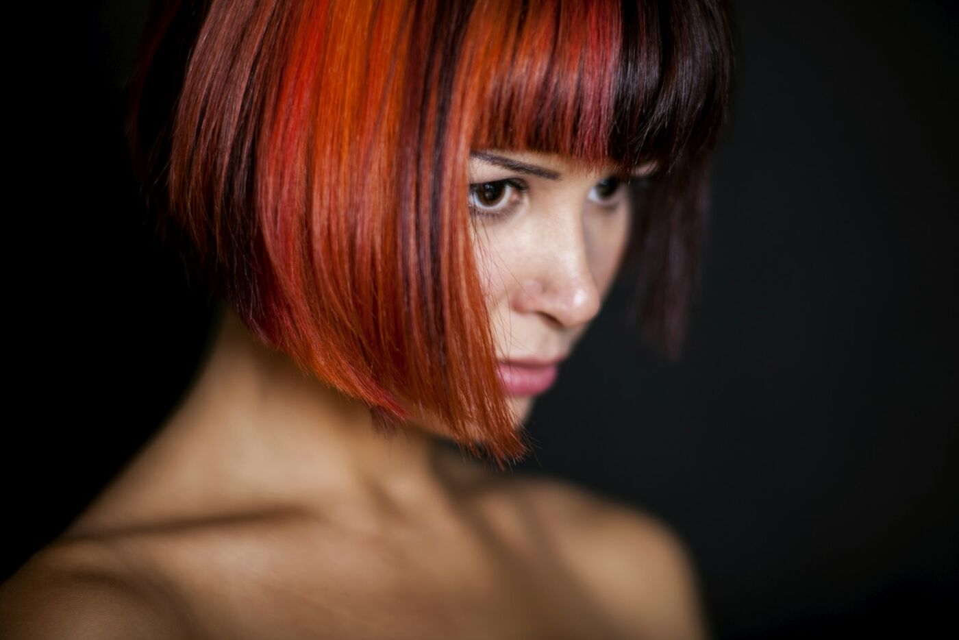 A sharp red bob with a straight fringe