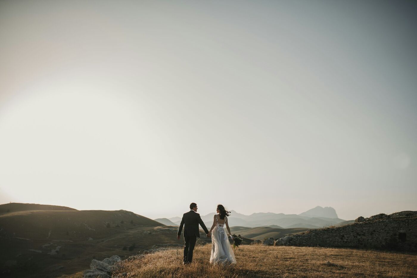 A couple walking together through misty hills